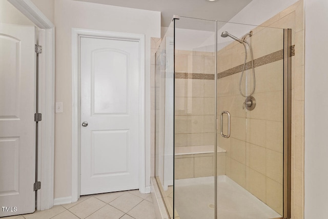 bathroom with tile patterned flooring and walk in shower