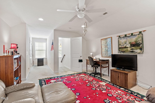 carpeted living room with ceiling fan and lofted ceiling