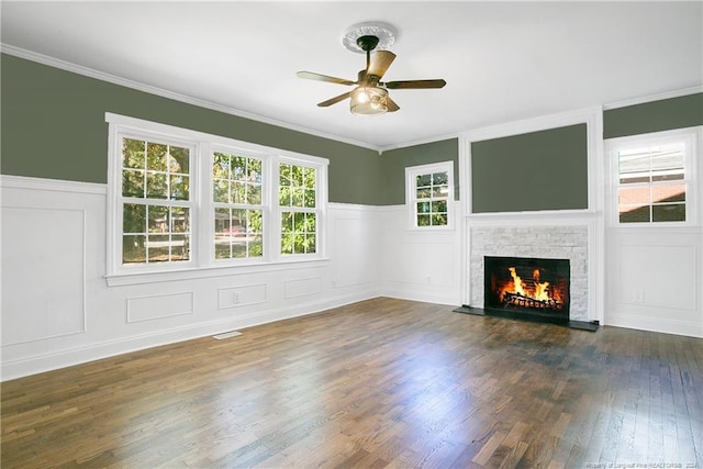 unfurnished living room with crown molding, dark hardwood / wood-style flooring, and ceiling fan