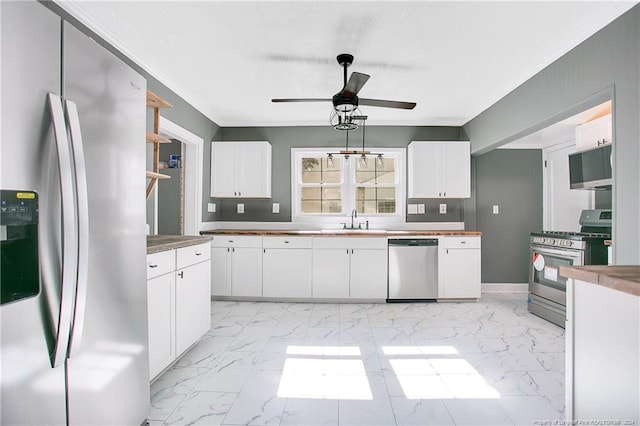 kitchen featuring white cabinetry, sink, ceiling fan, and stainless steel appliances