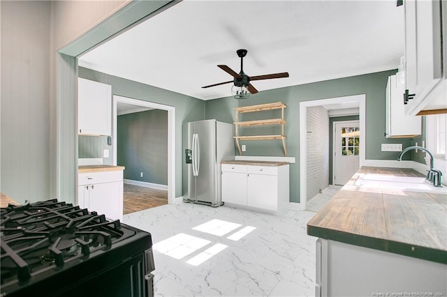 kitchen with white cabinets, stainless steel fridge with ice dispenser, and black gas stove