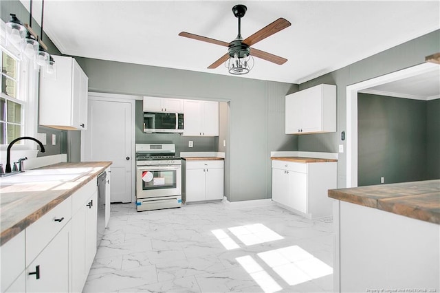 kitchen featuring ceiling fan, white cabinetry, sink, and appliances with stainless steel finishes