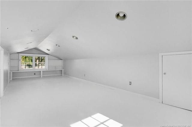 bonus room featuring light colored carpet and lofted ceiling