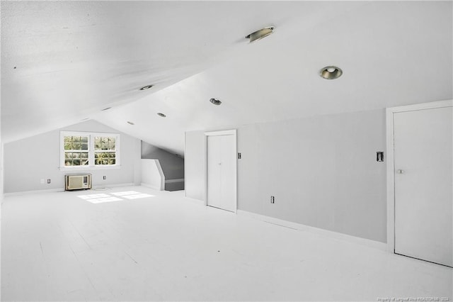 additional living space featuring vaulted ceiling