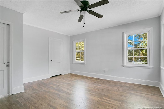 unfurnished bedroom featuring multiple windows, a textured ceiling, dark hardwood / wood-style flooring, and ceiling fan