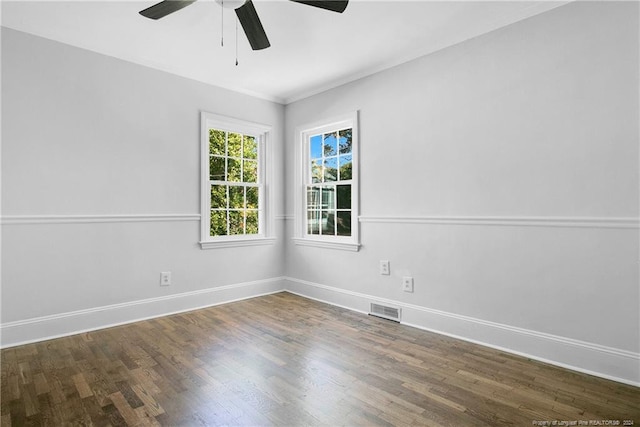 spare room with ceiling fan and dark hardwood / wood-style flooring