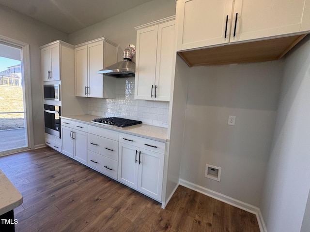 kitchen featuring white cabinetry, appliances with stainless steel finishes, dark hardwood / wood-style flooring, and tasteful backsplash