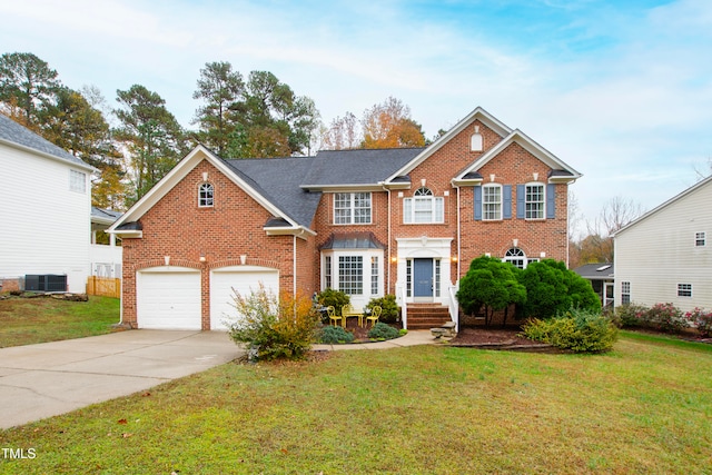 view of front facade featuring a front lawn, a garage, and central AC unit