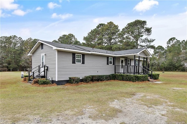 view of front of house featuring covered porch and a front lawn