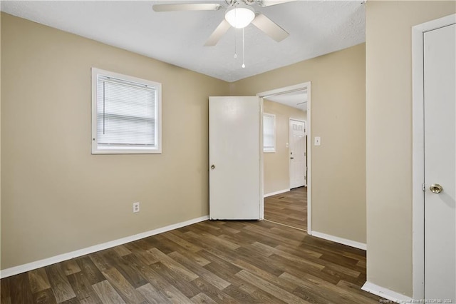 unfurnished room with dark hardwood / wood-style flooring and ceiling fan