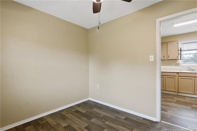 unfurnished room featuring dark hardwood / wood-style floors and sink