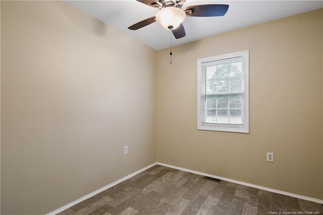 empty room with dark hardwood / wood-style flooring and ceiling fan