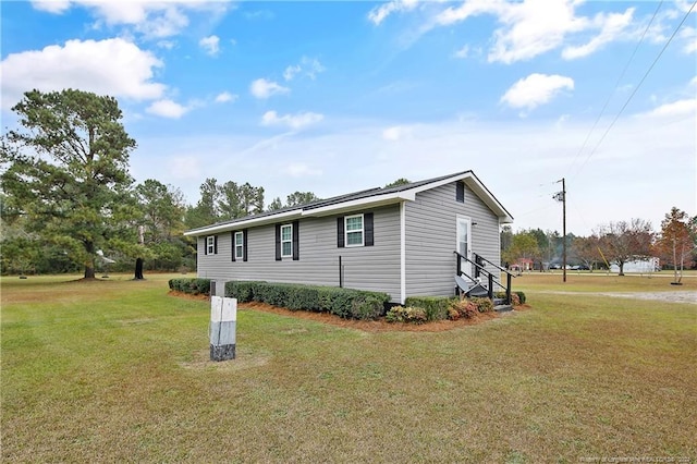 view of side of property with a lawn