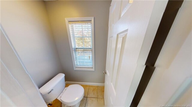 bathroom with toilet and tile patterned floors