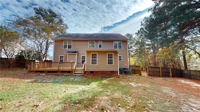 rear view of house with a yard and a wooden deck