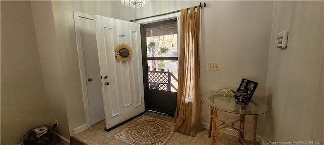 doorway with light tile patterned floors