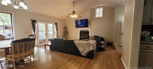 living room featuring hardwood / wood-style floors, a healthy amount of sunlight, and lofted ceiling