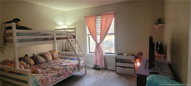 bedroom with a textured ceiling and carpet floors