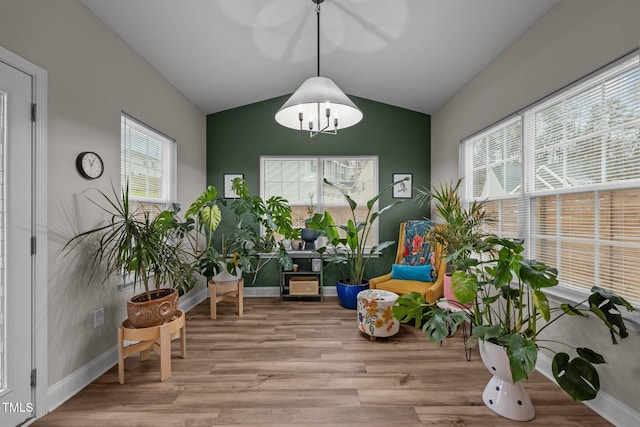 sitting room featuring light wood-type flooring and vaulted ceiling