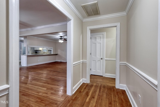 hall featuring crown molding and hardwood / wood-style flooring