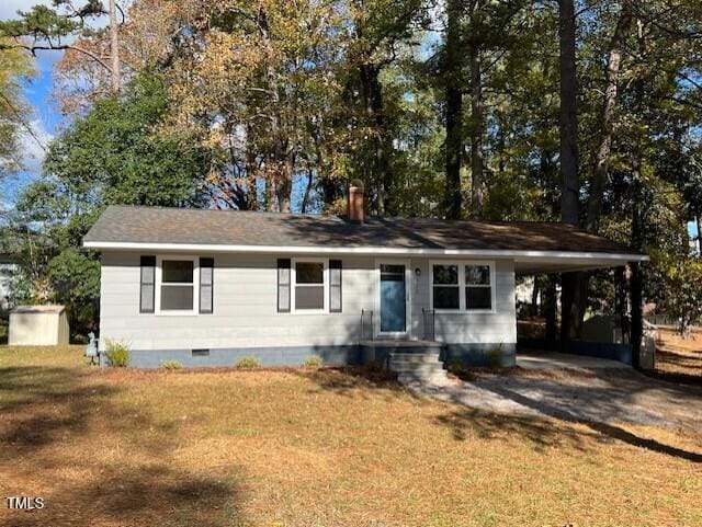 ranch-style home with a front yard and a carport