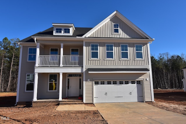 view of front of house featuring covered porch and a garage