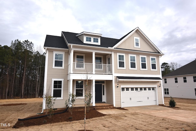 view of front of house with a garage and a balcony