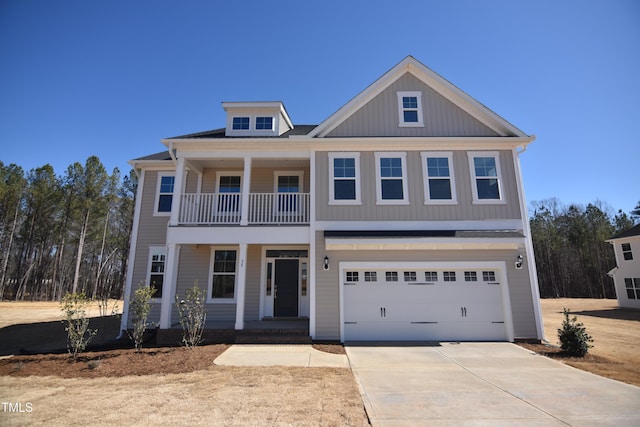 view of front of house featuring a porch, concrete driveway, a balcony, and an attached garage