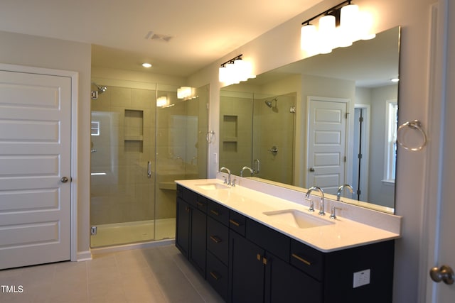 bathroom with a shower stall, visible vents, and a sink