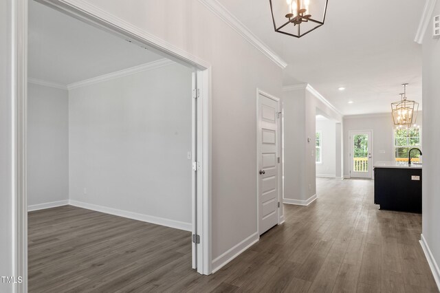 35 Accord Dr, Youngsville, NC 27596 - hall with a chandelier, baseboards, dark wood-style flooring, crown molding, and a sink