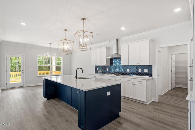 35 Accord Dr, Youngsville, NC 27596 - kitchen with wall chimney range hood, a sink, a chandelier, crown molding, and tasteful backsplash