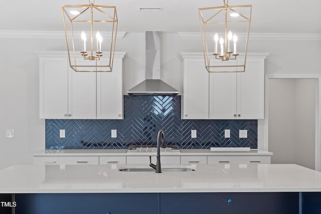 35 Accord Dr, Youngsville, NC 27596 - kitchen featuring a chandelier, wall chimney exhaust hood, a sink, tasteful backsplash, and crown molding