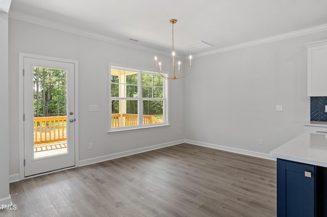 35 Accord Dr, Youngsville, NC 27596 - unfurnished dining area with a chandelier, ornamental molding, wood finished floors, and baseboards