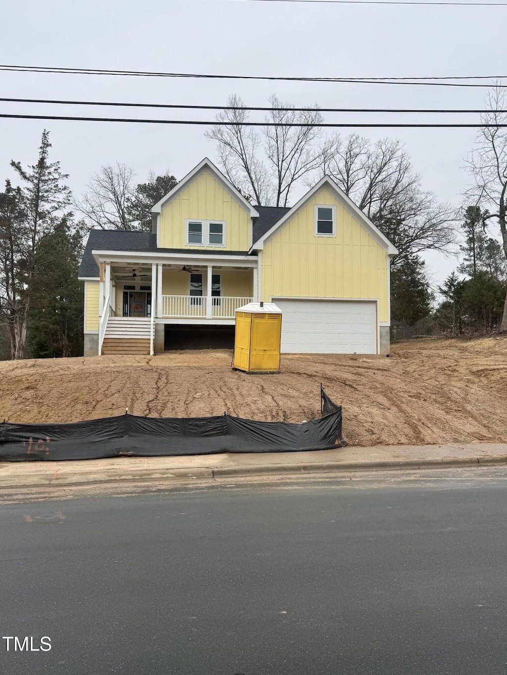 view of front facade with a garage and a porch