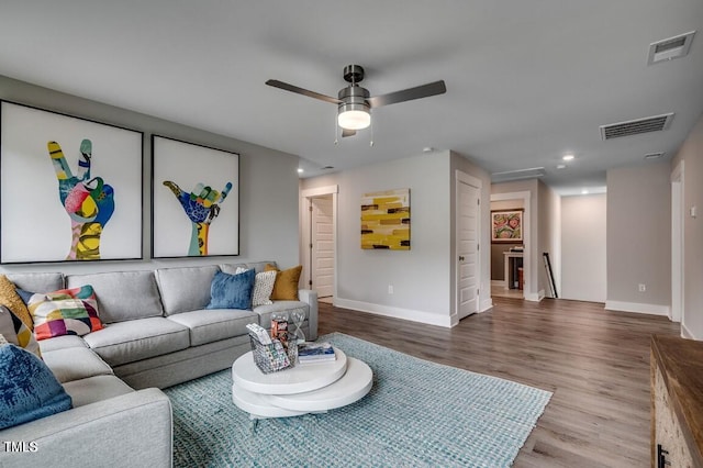 living room with hardwood / wood-style flooring and ceiling fan