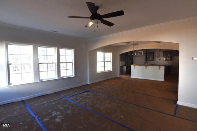 unfurnished living room featuring ceiling fan with notable chandelier and ornamental molding