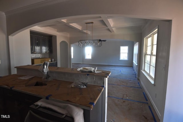 kitchen featuring sink, ornamental molding, hanging light fixtures, coffered ceiling, and beam ceiling