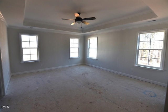 spare room featuring ornamental molding, ceiling fan, and a raised ceiling