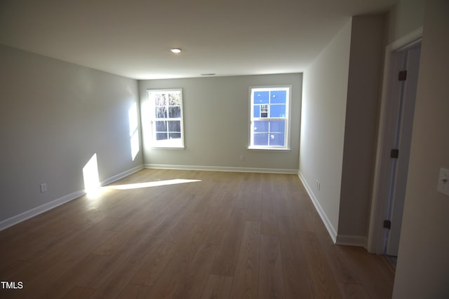 unfurnished room with wood finished floors and baseboards