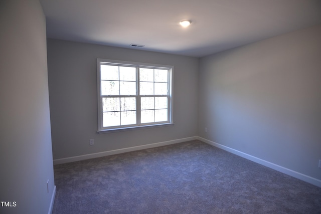 carpeted empty room with visible vents and baseboards