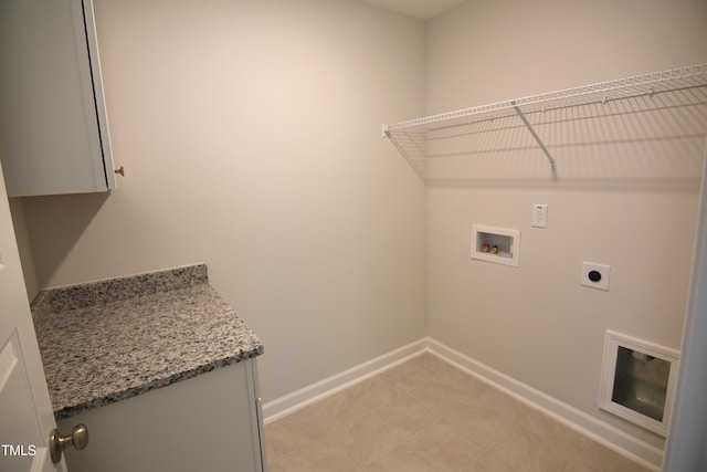 clothes washing area featuring cabinet space, baseboards, washer hookup, and hookup for an electric dryer