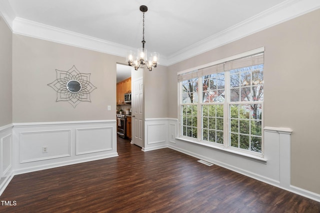 unfurnished dining area with a chandelier, dark hardwood / wood-style flooring, and crown molding