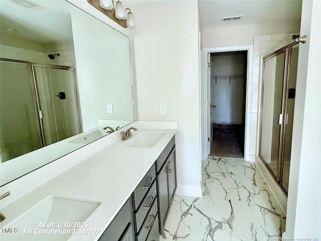 bathroom featuring walk in shower and vanity