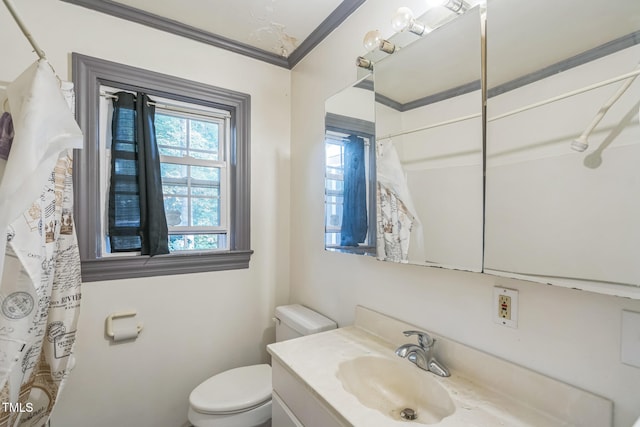 bathroom featuring crown molding, vanity, and toilet