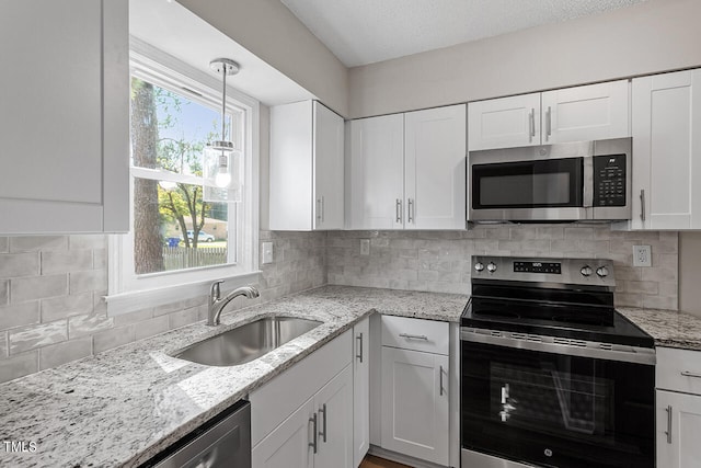 kitchen featuring stainless steel appliances and white cabinetry