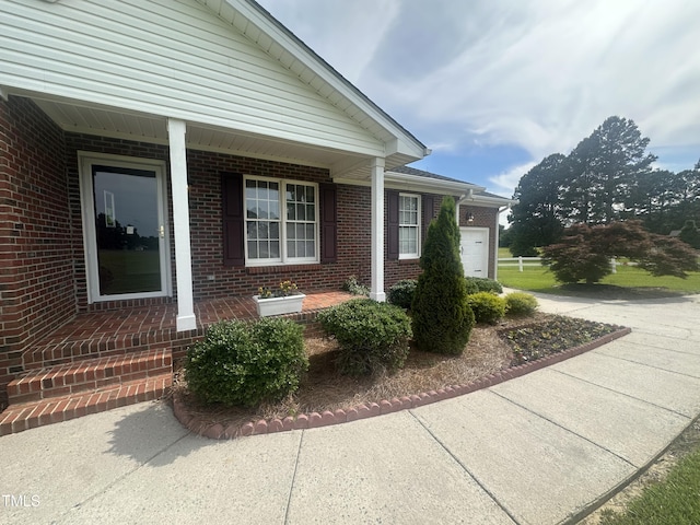 5148 Benson Rd, Angier, NC 27501 - view of side of property featuring brick siding, a garage, and a porch