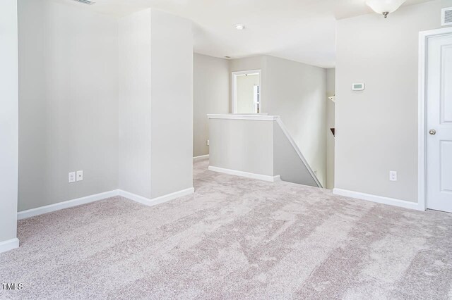 empty room featuring light colored carpet