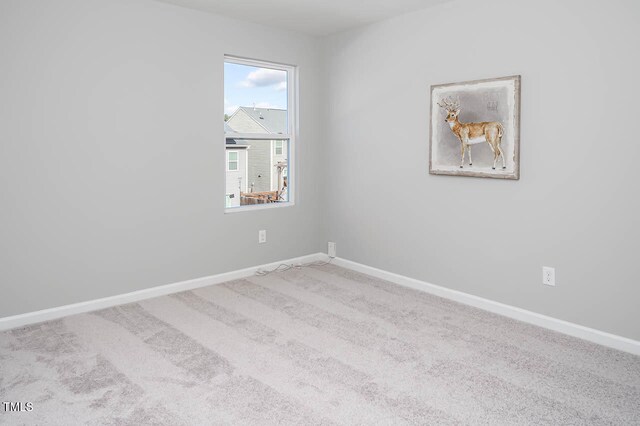 spare room with light carpet