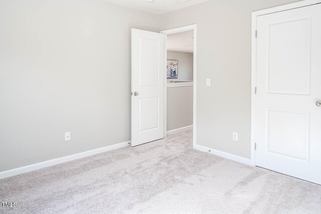 unfurnished bedroom featuring light colored carpet