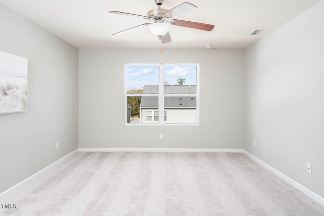 carpeted empty room featuring ceiling fan